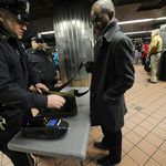 Cops check a bag at Grand Central subway station